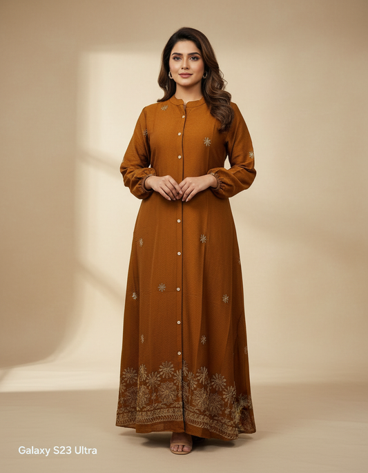 Woman wearing a long brown dress with floral patterns on a beige background